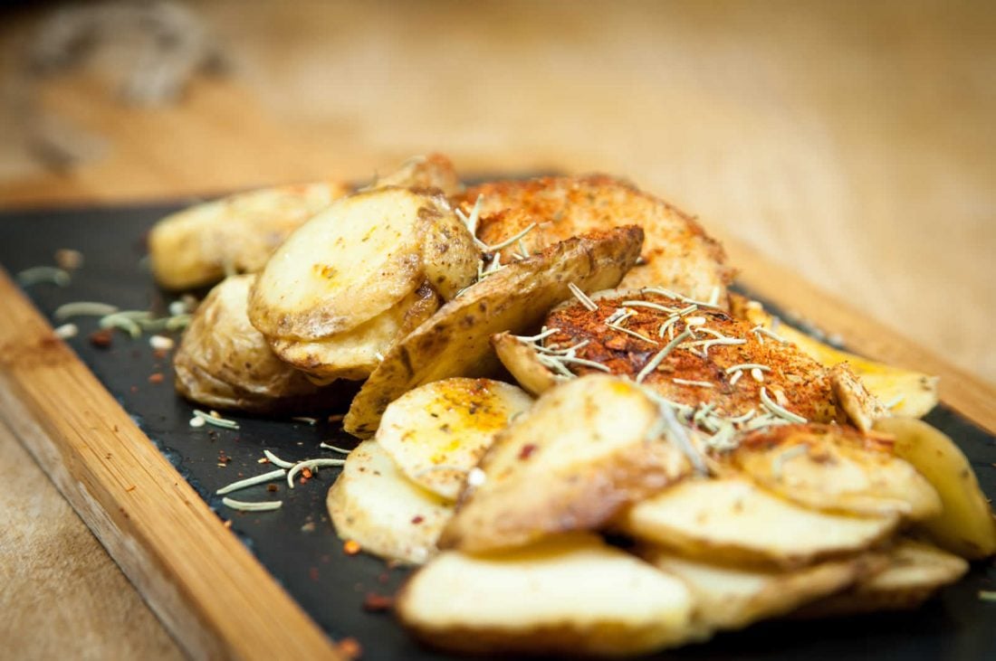Roasted patatas on a tapas board in Bar Celoneta