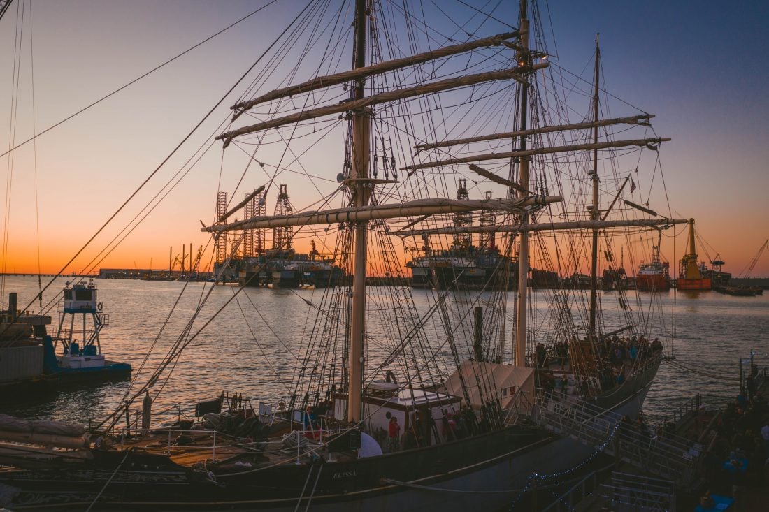 A sailing ship at sunset in Elissa seaport museum in galveston .