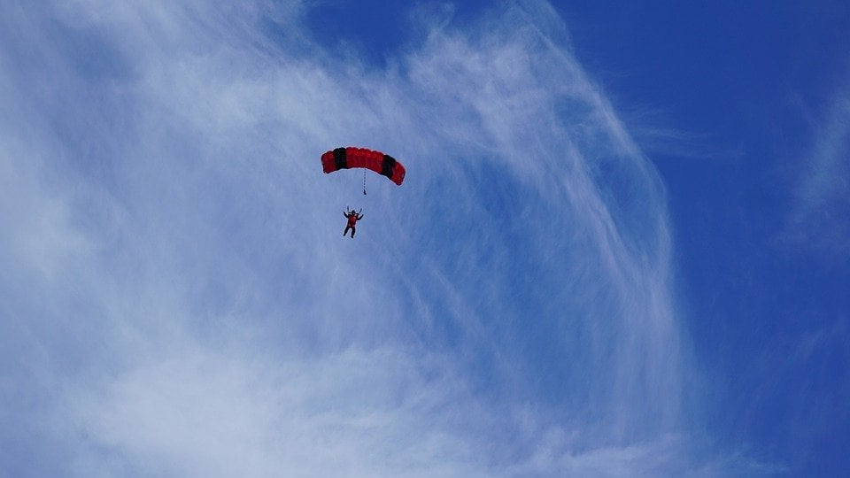 a parachute of a skydiver against a blue sky