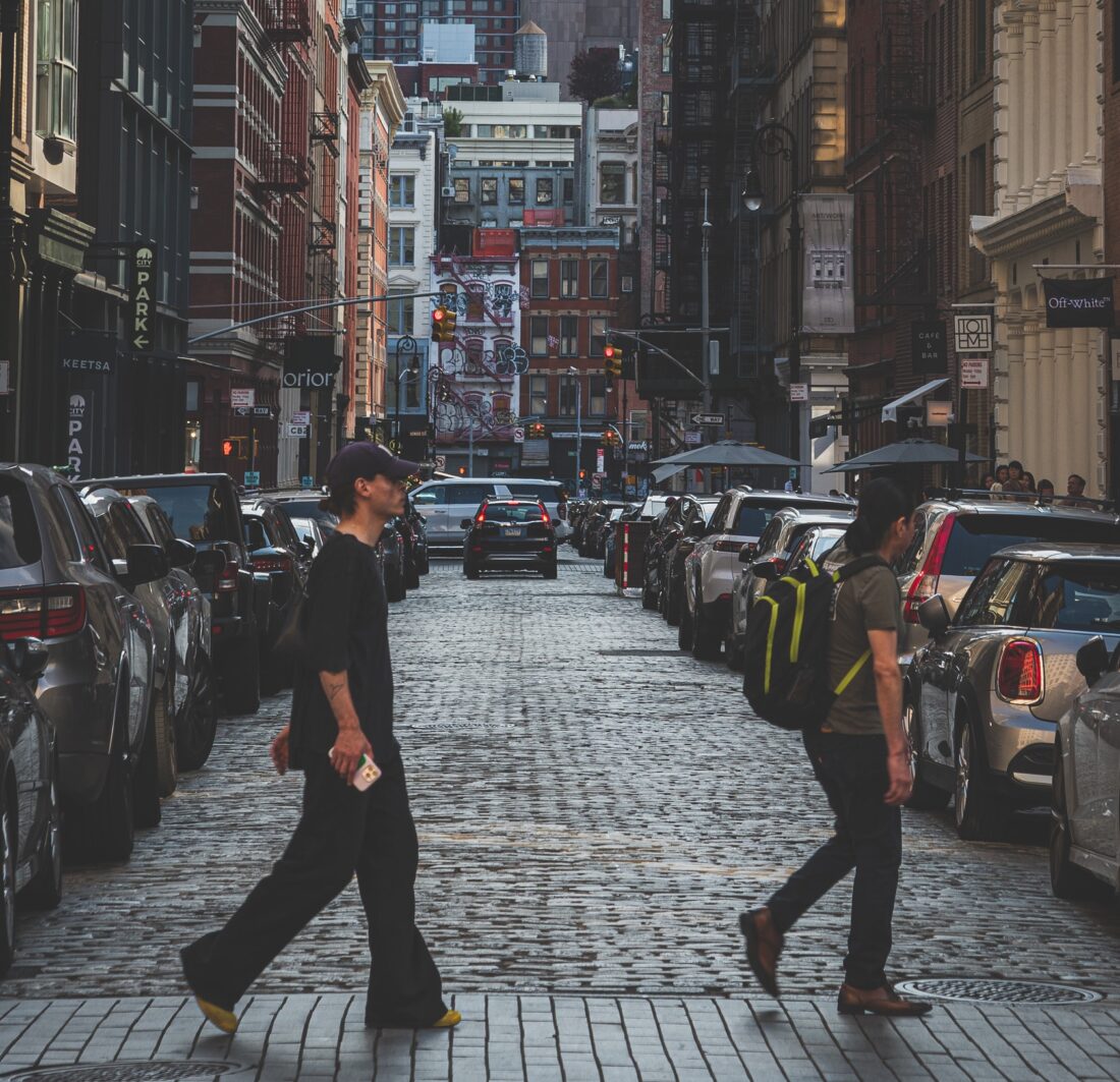 Man and woman crossing the street in SoHo, NYC.