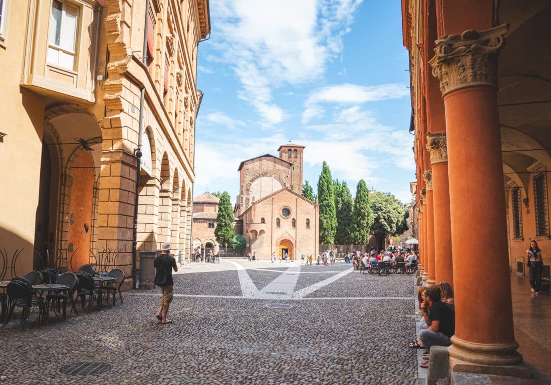 People sitting under a portico at san stefano piazza bologna italy