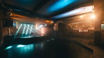 Café V lese's concert space with a large floor, the stage, and the bar. 