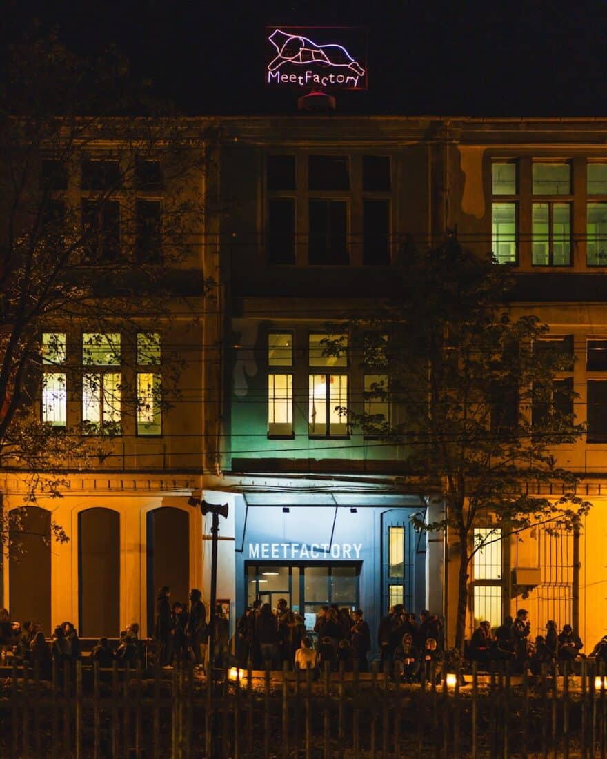 A nighttime view of fans gathered outside the entrance to MeetFactory, one of the best live music venues in Prague for mid-sized acts. 