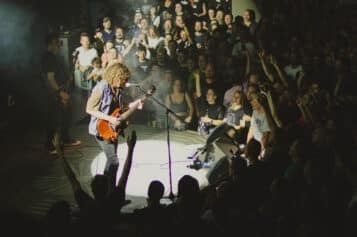 Wolfmother performing on Lucerna Music Bar's unique stage surrounded by fans. 