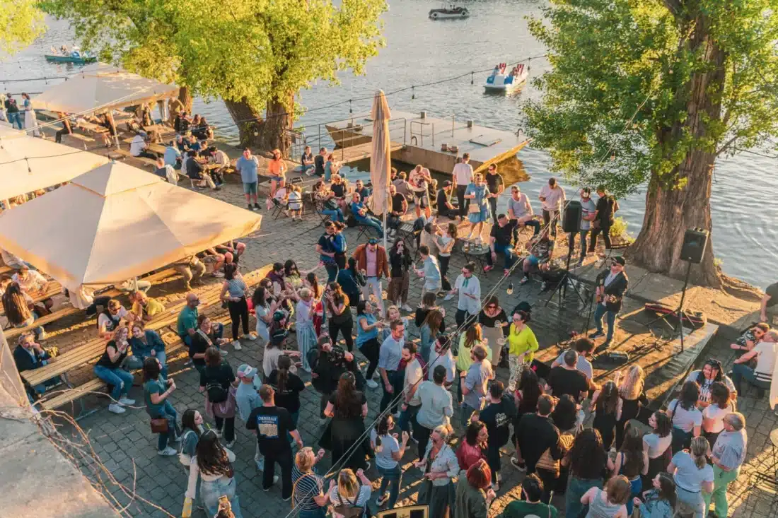 People outside at Náplavka near the river, the best Prague alternative to your summer neighborhood DORA.