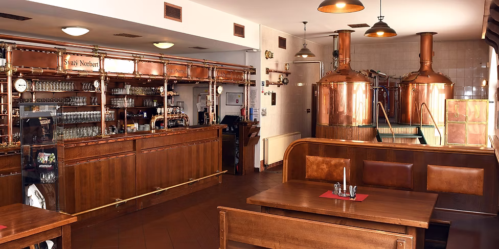 The interior of the Strahov Monastery Brewery, complete with bright tanks at the side.