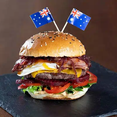 A burger with Australian flags stuck into the top bun at The Down Under.